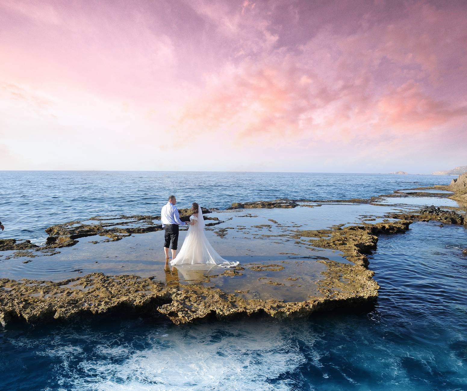 photo of couple on seashore during dawn