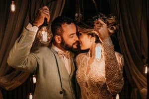 man and woman holding lights while kissing