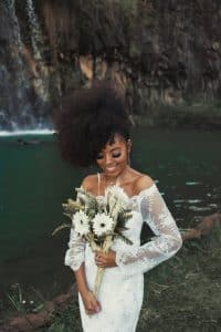 standing woman wearing white long sleeved dress