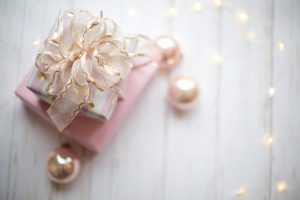 two pink and white gift boxes with ribbon