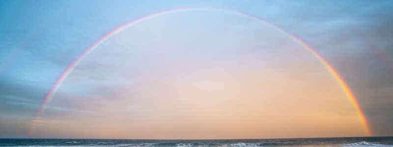 rainbow over rippling sea in nature