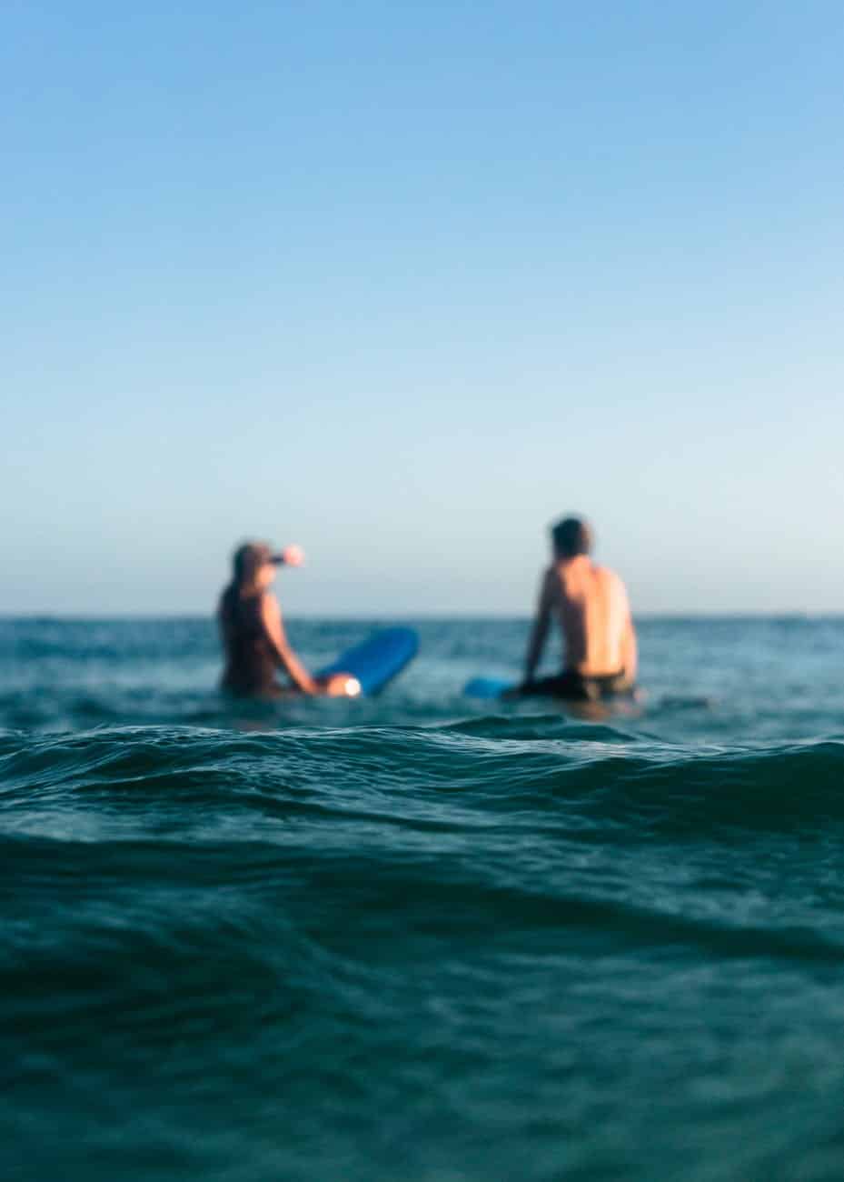 two person riding blue bodyboard