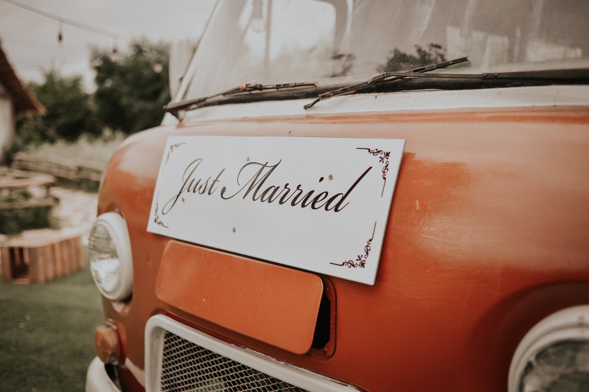 just married plank board in front of red van