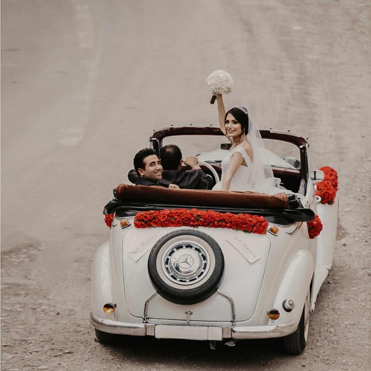 groom and bride riding on white vehicle
