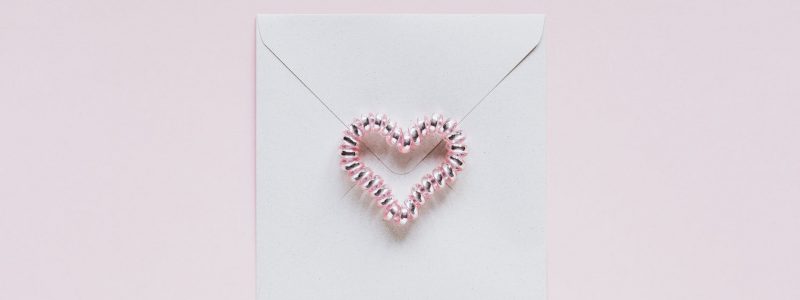 envelope with handmade bead heart on san valentines day