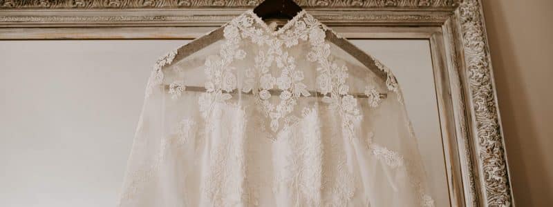 elegant bridal dress hanging on mirror