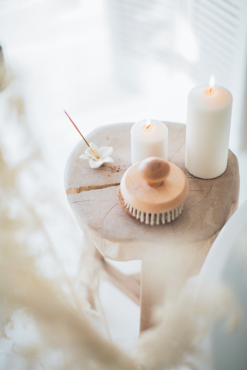 incense and white candles on a stool