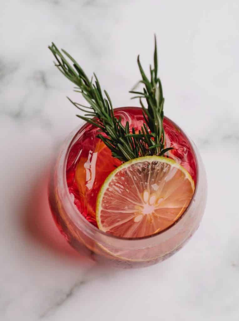 glass of refreshing drink with grapefruit and rosemary