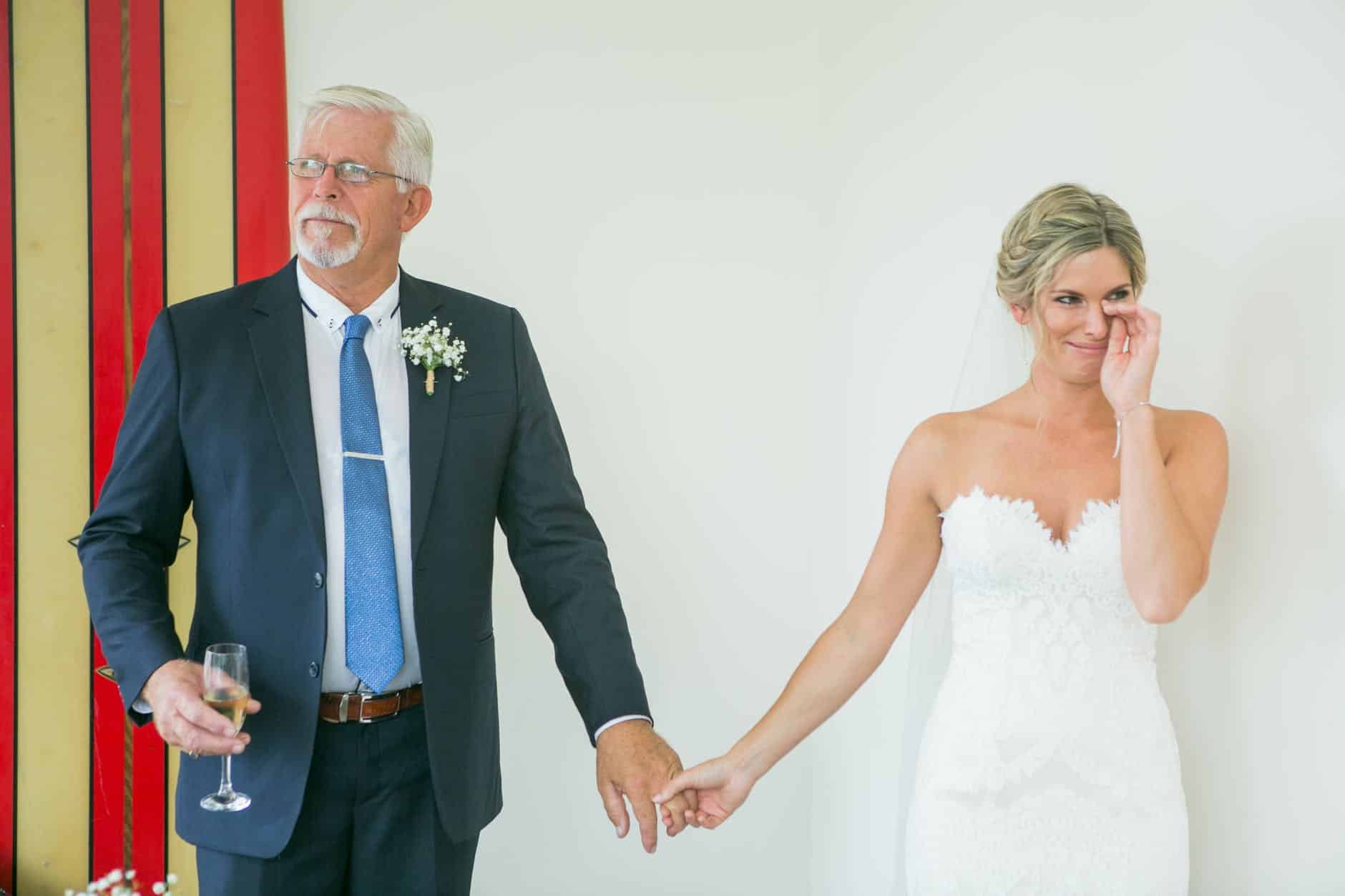 emotional bride with father during wedding celebration